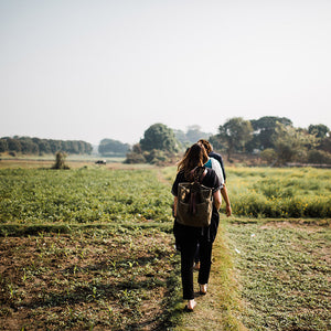 Photo of women walking on field in rural Bangladesh. Photo taken by Adrienne Gerber Photography