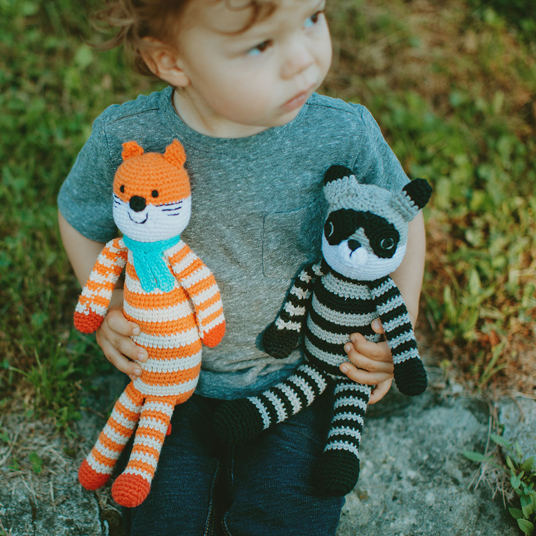 Boy holding Plush Raccoon and Fox Kids Toys