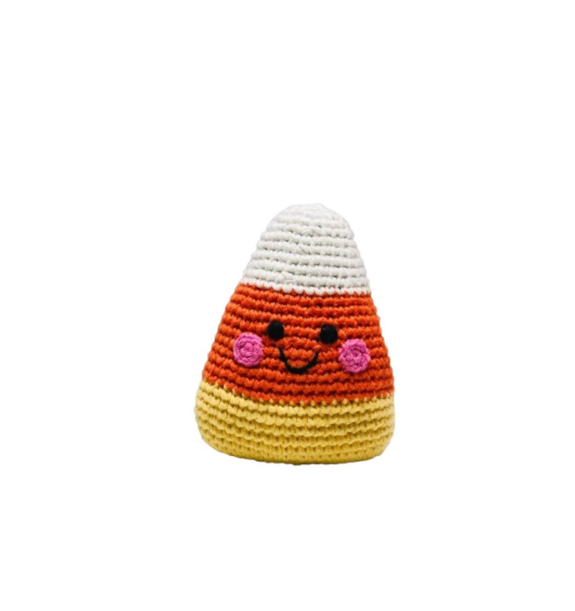 Crocheted candy corn toy with a smiling face on a white background
