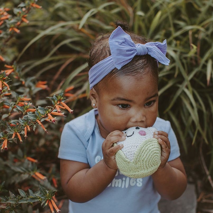Baby girl holding stuffed Cauliflower Plush Toy