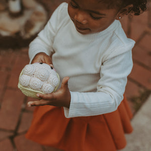 Girl playing with handmade crochet Cauliflower Plush Toy Rattle