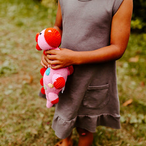 Girl holding Handmade Crochet Organic Cotton Dino