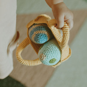 Toddler holding basket with handmade Easter Egg Plush Toys