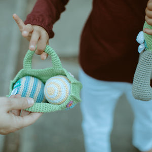 Child holding Fair Trade Basket with Organic Cotton Easter Egg Toys
