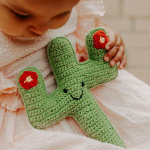 Girl holding handmade Pebble Cactus toy