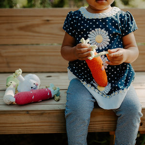 Girl holding Handmade Crochet Orange Carrot Plush Toy