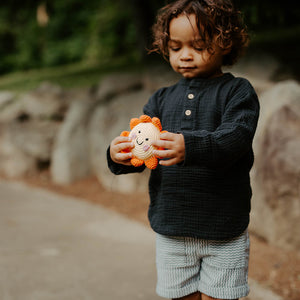 Child holding handmade sun baby toy rattle