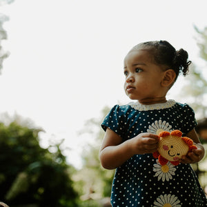 Girl with plush sun baby toy