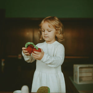 Girl holding Organic Cotton Red Cherry Plush Toy