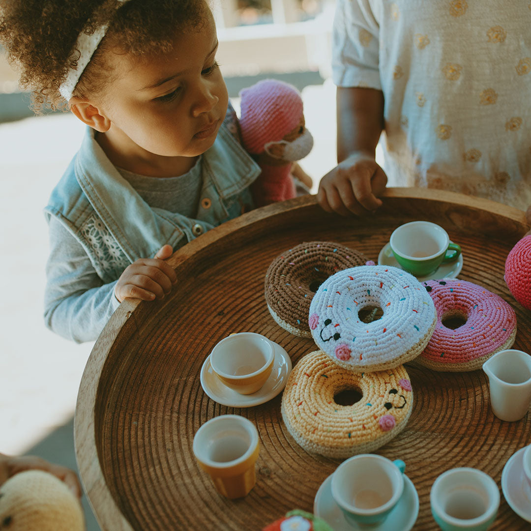 Tea party with multi colored handmade plush toy donut rattles