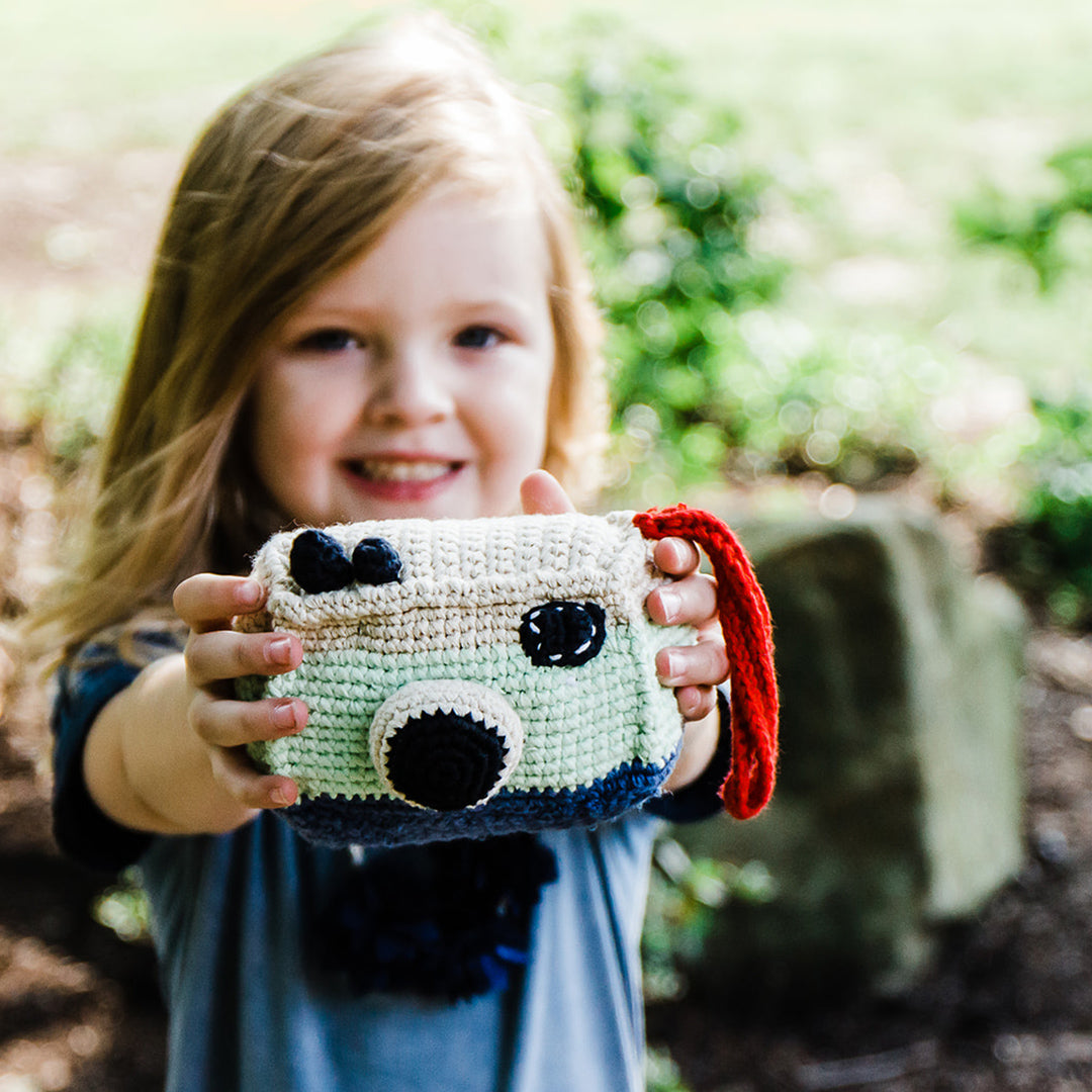 Girl holding crochet plush toy camera