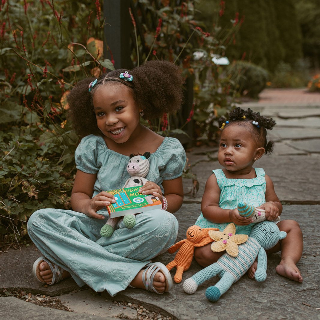 Siblings with book and matching toys