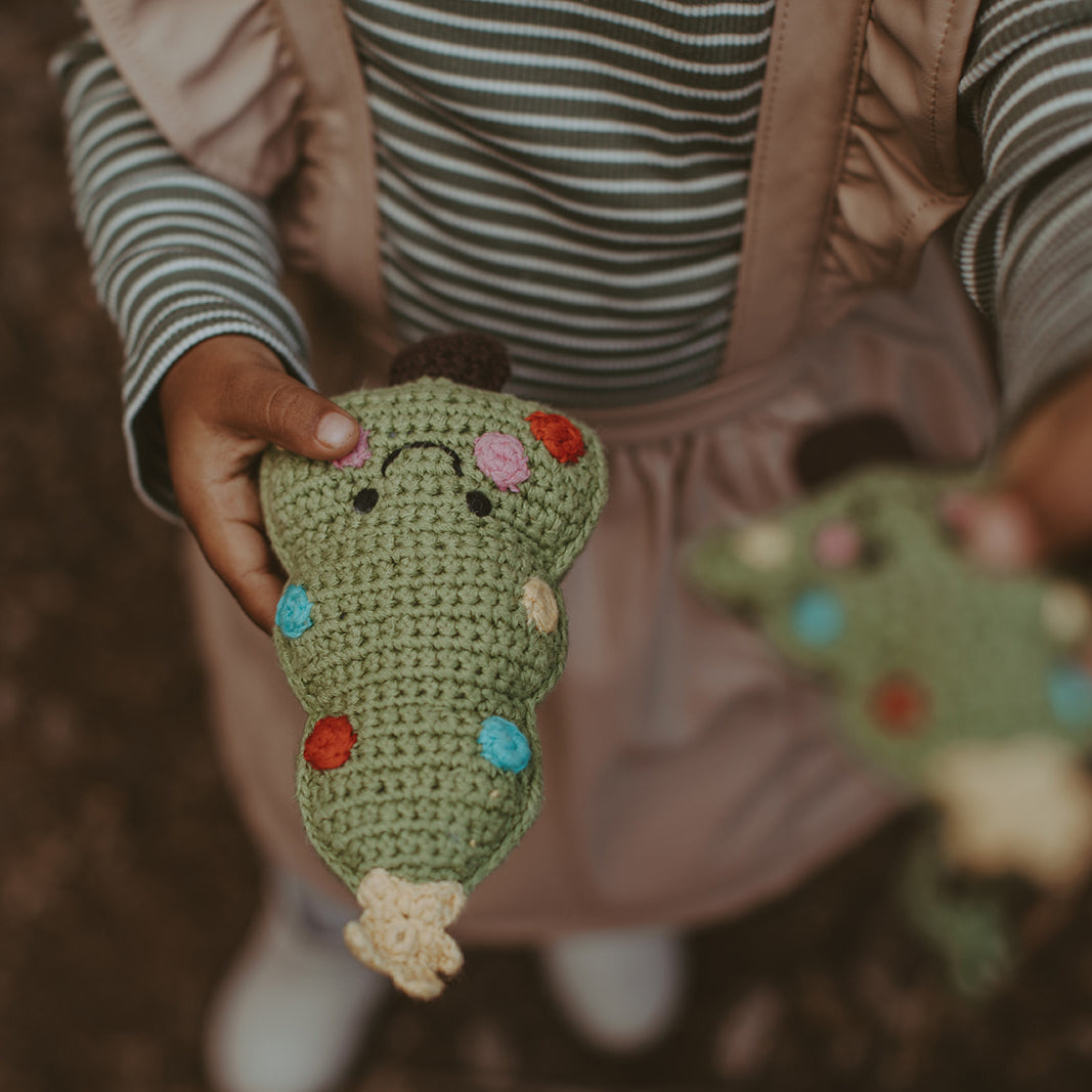 Girl holding crochet plush Christmas Tree