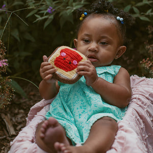 GIrl holding crochet cotton jam toast toy