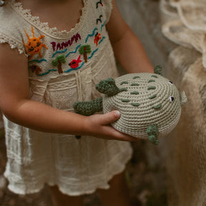 Toddler holding handmade Pufferfish toy