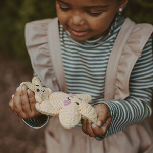 Girl holding handmade fair trade star rattle and matching star ornament