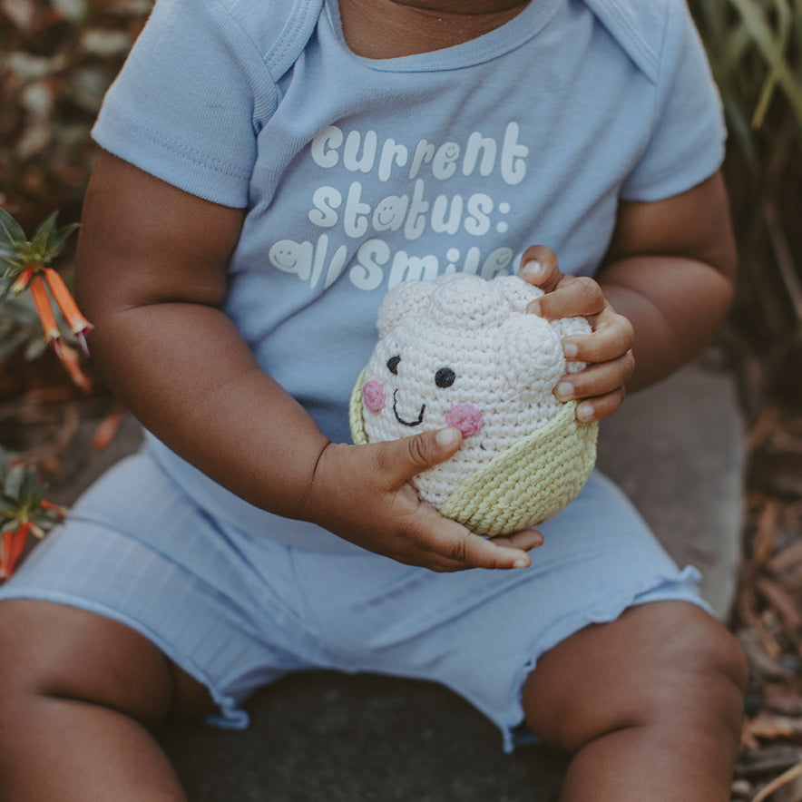 Baby holding Fair Trade Plush Cauliflower Baby Toy