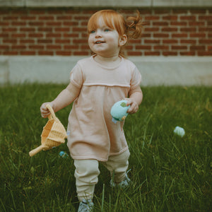 Girl walking in Grass with Easter Basket and Easter Egg Plush Toy