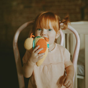 Girl holding Yellow Duck Baby Toy Rattle