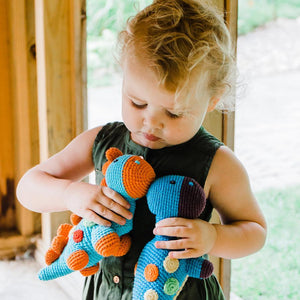 Girl holding Turquoise Dinosaur Rattles