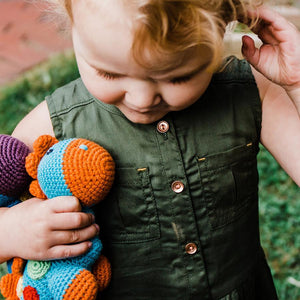 Toddler with Handmade Organic Cotton Toy Dino