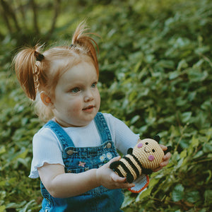 Girl with Fair Trade Handmade Bumble Bee Baby Toy Rattle