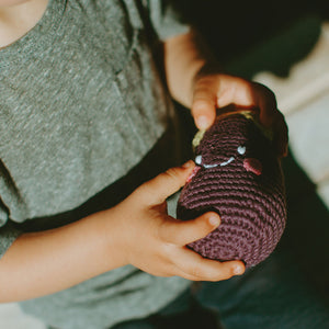 Toddler holding Handmade Crochet Purple Egglplant Soft Toy