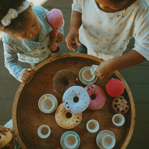 Girls having tea party with handmade crochet chocolate chip cookie and donut soft toys